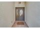 Front entryway with decorative glass door and tiled floor at 11386 Churchhill Trl, Seminole, FL 33772