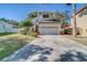 This two-story home features an attached two-car garage and well-manicured landscaping at 11386 Churchhill Trl, Seminole, FL 33772
