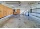 Large two car garage with bright lighting, built-in cabinets, and epoxy flooring at 11386 Churchhill Trl, Seminole, FL 33772