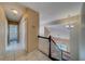 Upstairs hallway with tile flooring, a staircase with dark wood railing, and hanging lights at 11386 Churchhill Trl, Seminole, FL 33772