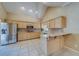 Bright eat-in kitchen with tile floors, stainless steel appliances, and light wood cabinets at 11386 Churchhill Trl, Seminole, FL 33772