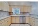 Kitchen featuring light wood cabinets, stainless steel appliances, and modern sink with window views at 11386 Churchhill Trl, Seminole, FL 33772