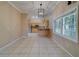 Open concept kitchen features tile floors, ample cabinets, stainless steel appliances, and a breakfast bar at 11386 Churchhill Trl, Seminole, FL 33772