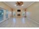 Bright living room featuring a fireplace, ceiling fan, neutral walls, and access to outdoor space at 11386 Churchhill Trl, Seminole, FL 33772