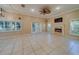 Spacious living room features neutral walls, tile floors, a fireplace, and double doors to the outside at 11386 Churchhill Trl, Seminole, FL 33772