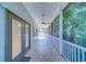 Covered and screened porch with tile flooring and ceiling fans for outdoor comfort at 11386 Churchhill Trl, Seminole, FL 33772