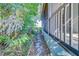 Stone pathway runs along the side of the house through lush greenery at 11386 Churchhill Trl, Seminole, FL 33772