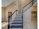 Staircase with dark wood treads and white spindles connects the living spaces at 11386 Churchhill Trl, Seminole, FL 33772