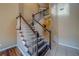 Elegant staircase with dark wood treads and white spindles lead to the second floor at 11386 Churchhill Trl, Seminole, FL 33772