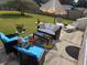 Cozy patio with stylish outdoor furniture, vibrant rug, and lush green lawn, perfect for relaxing and entertaining at 1142 56Th N Ave, St Petersburg, FL 33703