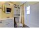 Well-lit bathroom with a vanity sink and a shower with a decorative shower curtain and tile at 1142 56Th N Ave, St Petersburg, FL 33703