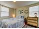 Cozy bedroom with a blue quilt, and woven chest of drawers, illuminated by natural light at 1142 56Th N Ave, St Petersburg, FL 33703