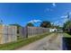 Long gravel driveway lined with a wooden fence offering privacy and a sense of seclusion at 1142 56Th N Ave, St Petersburg, FL 33703