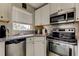 Well-equipped kitchen featuring stainless steel appliances and granite counters for cooking at 1142 56Th N Ave, St Petersburg, FL 33703