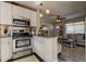 Open kitchen featuring stainless steel appliances and a breakfast bar adjacent to the living area at 1142 56Th N Ave, St Petersburg, FL 33703