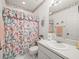 Bathroom showcasing a sink, toilet, and patterned shower curtain at 11510 Shipwatch Dr # 1375, Largo, FL 33774