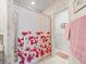 Bathroom showing bathtub with patterned shower curtain and adjacent room at 11510 Shipwatch Dr # 1375, Largo, FL 33774