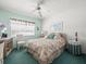 Comfortable bedroom with desk, window, bed and floral decor at 11510 Shipwatch Dr # 1375, Largo, FL 33774