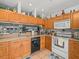 Well-lit kitchen featuring modern appliances and charming decor on top of cabinets at 11510 Shipwatch Dr # 1375, Largo, FL 33774