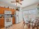 Cozy kitchen with white appliances, wood cabinets, and adjacent breakfast nook at 11510 Shipwatch Dr # 1375, Largo, FL 33774