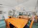 Comfortable living space with a dining area, leather sofa, and a view of the lanai at 11510 Shipwatch Dr # 1375, Largo, FL 33774