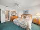 Inviting main bedroom with a ceiling fan, comfortable bed, and en-suite bathroom access at 11510 Shipwatch Dr # 1375, Largo, FL 33774