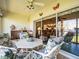 A sunny patio with comfortable seating and a view into the bright and open living room at 11510 Shipwatch Dr # 1375, Largo, FL 33774