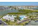 Aerial view of pool and waterways near residential buildings with beautiful ocean views in the background at 11510 Shipwatch Dr # 1375, Largo, FL 33774