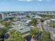 Aerial view of community tennis courts near the water, with a building and parking area nearby at 11510 Shipwatch Dr # 1375, Largo, FL 33774