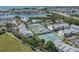 Aerial view of tennis courts and waterways with buildings, docks and ocean views nearby at 11510 Shipwatch Dr # 1375, Largo, FL 33774