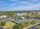 Aerial view of tennis courts surrounded by lush greenery and community buildings and parking at 11510 Shipwatch Dr # 1375, Largo, FL 33774