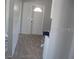 Inviting entryway featuring wood-look floors and a white front door with arched window at 1228 Pineview Ave, Clearwater, FL 33756