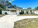 Charming single-story home featuring a well-maintained front yard and a classic white picket fence at 1228 Pineview Ave, Clearwater, FL 33756