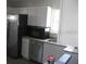 Bright kitchen featuring stainless steel appliances, white cabinets, and stone countertops at 1228 Pineview Ave, Clearwater, FL 33756