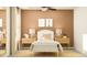 Bedroom with a neutral colour scheme, framed wall art, and matching end tables at 12605 Aura Moonlight Ter, Parrish, FL 34219