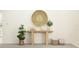 Elegant entryway with wood console table, decorative baskets, and statement wall art at 12605 Aura Moonlight Ter, Parrish, FL 34219