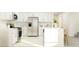 Modern kitchen with stainless steel appliances, white cabinetry, and a center island at 12605 Aura Moonlight Ter, Parrish, FL 34219