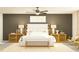 Serene bedroom with a king-sized bed, stylish lamps, and a neutral color palette at 12605 Aura Moonlight Ter, Parrish, FL 34219