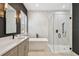 Elegant bathroom featuring a soaking tub, glass shower, double vanity, and stylish fixtures at 12707 Green Heron Way, Odessa, FL 33556