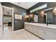 Stylish bathroom featuring double vanity, dark accent wall, and modern fixtures at 12707 Green Heron Way, Odessa, FL 33556