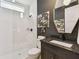 Contemporary bathroom with a glass-enclosed shower, dark vanity, and modern fixtures at 12707 Green Heron Way, Odessa, FL 33556