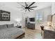 Well-lit bedroom with a full bed, a desk, and a ceiling fan at 12707 Green Heron Way, Odessa, FL 33556