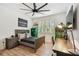 Stylish bedroom with a wooden bed frame, desk, and natural light at 12707 Green Heron Way, Odessa, FL 33556