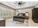Serene main bedroom featuring a tray ceiling, shutters, and neutral decor at 12707 Green Heron Way, Odessa, FL 33556