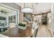 A dining area adjacent to an open kitchen, with a sliding glass door to outdoor patio seating at 12707 Green Heron Way, Odessa, FL 33556