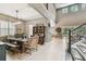Open-concept dining area with a farmhouse table, decor shelving, and lots of natural light at 12707 Green Heron Way, Odessa, FL 33556