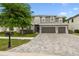 Charming two-story home with a well-kept lawn, mailbox, and a three-car garage at 12707 Green Heron Way, Odessa, FL 33556