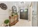 Elegant foyer featuring a decorative clock, console table, and stylish flooring at 12707 Green Heron Way, Odessa, FL 33556