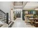 Spacious foyer leads to the dining area with modern wet bar and staircase at 12707 Green Heron Way, Odessa, FL 33556