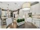 Open kitchen with white cabinetry, large island, pendant lighting, and adjacent dining area at 12707 Green Heron Way, Odessa, FL 33556